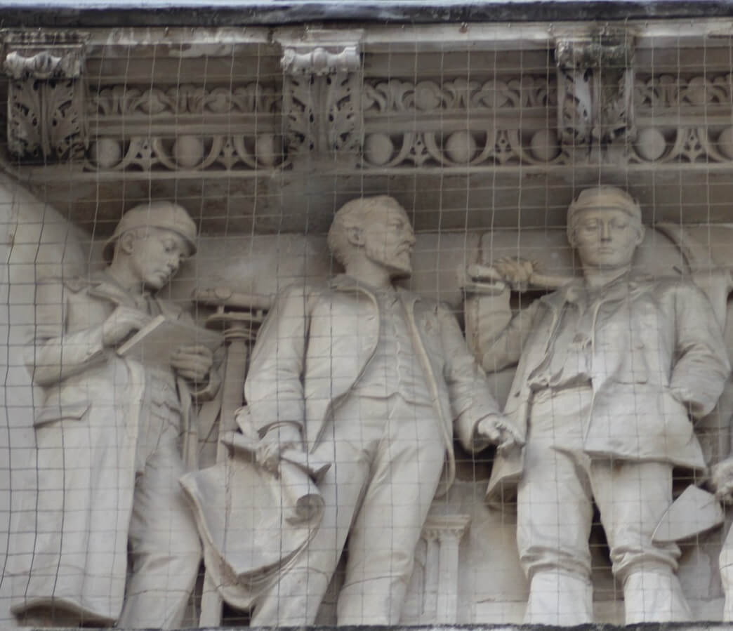 Photograph of 3 statues on the exterior of the building