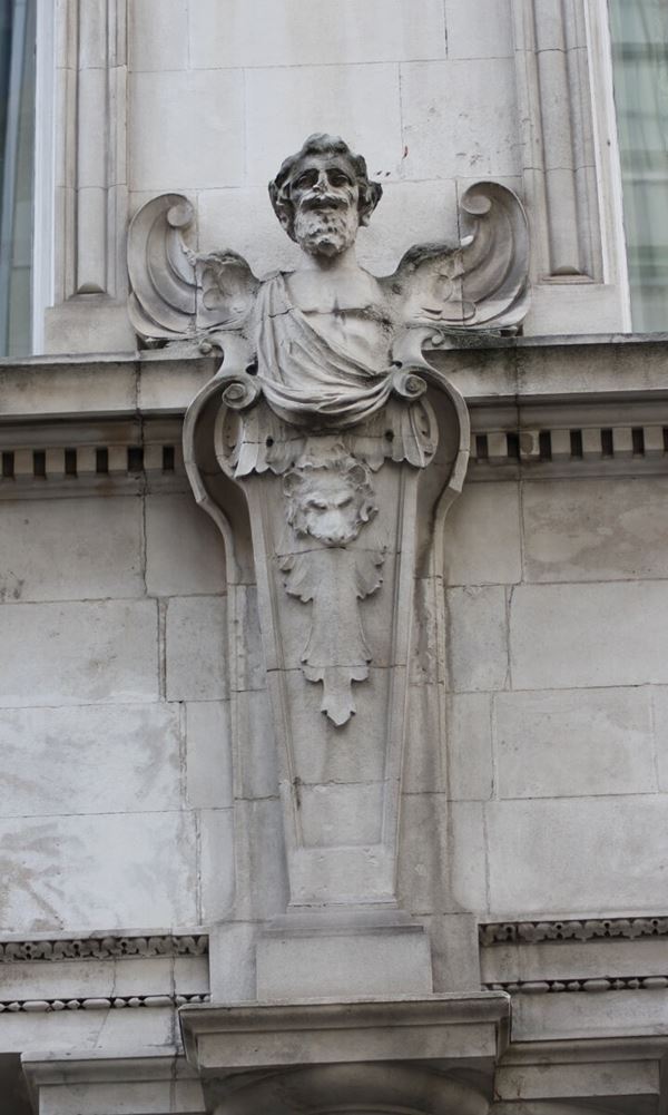 Photograph of a stone carved angel on the building exterior