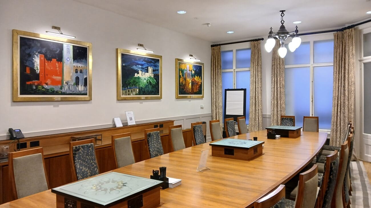 a picture of  a boardroom with paintings on the wall