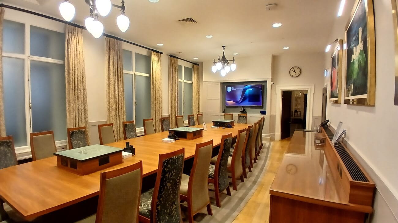 a picture of  a boardroom with paintings on the wall