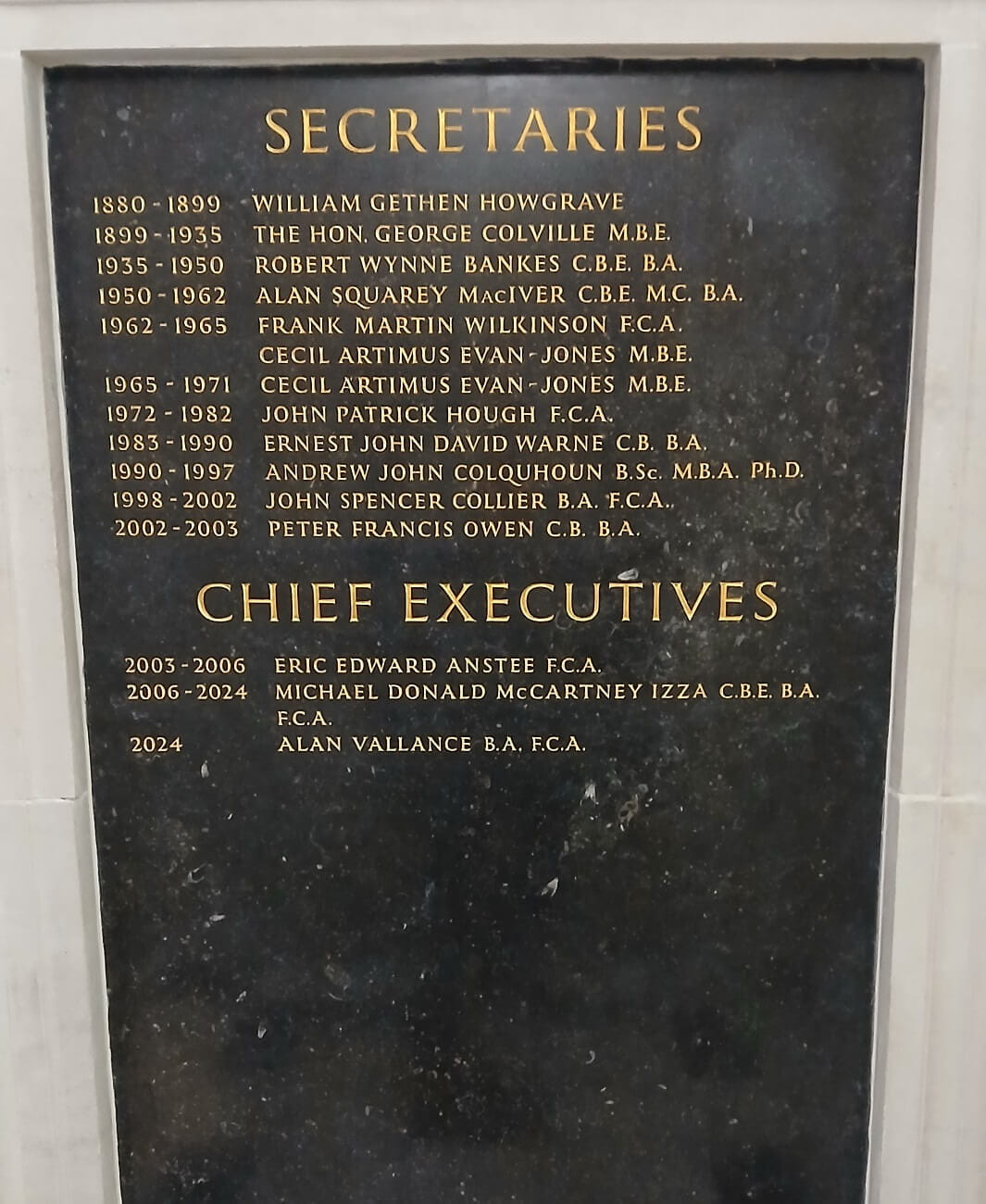 Photograph of a plaque listing names under headings Secretaries and Chief Executives