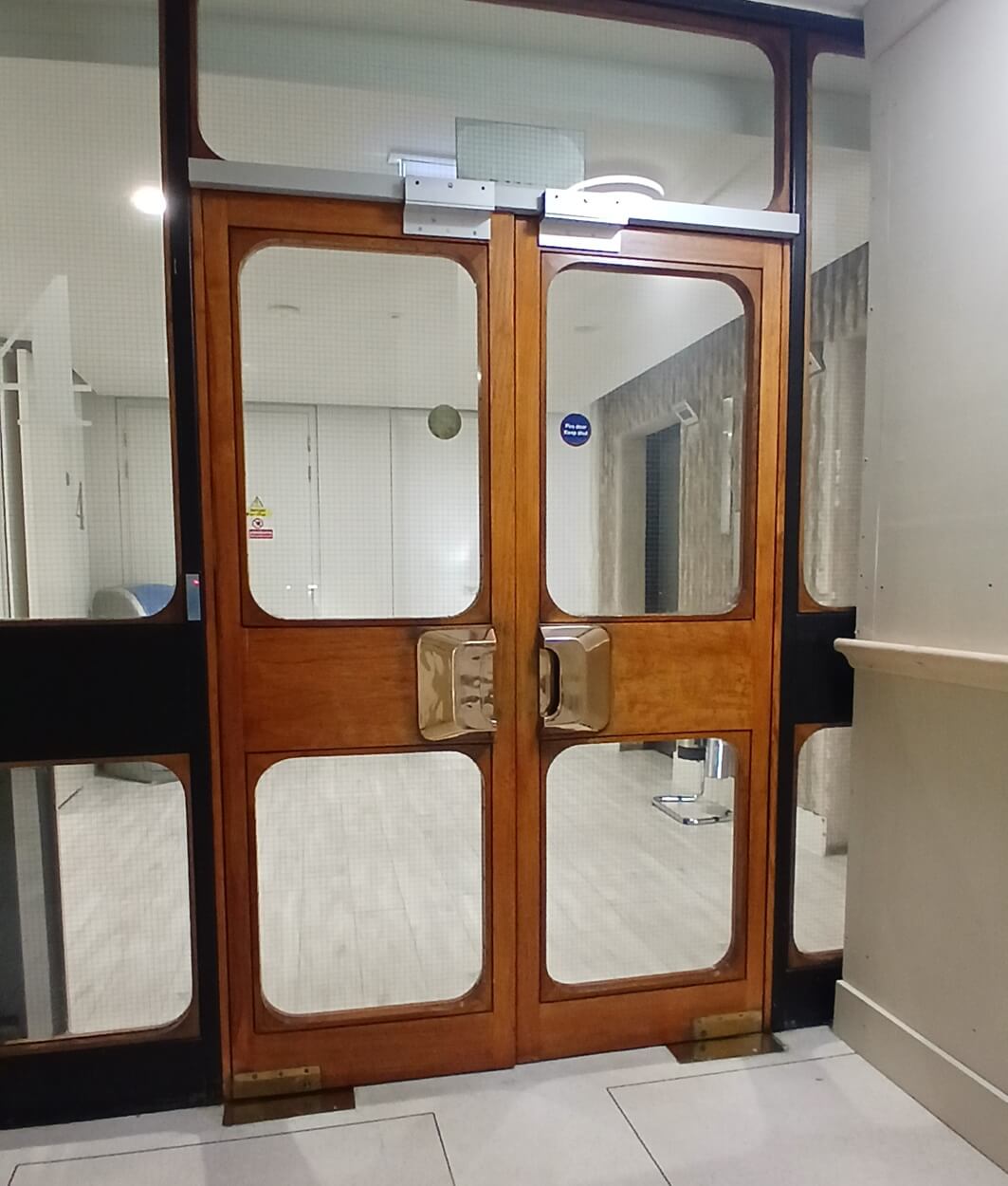 an image of some glazed hard wood doors leading to a lift lobby