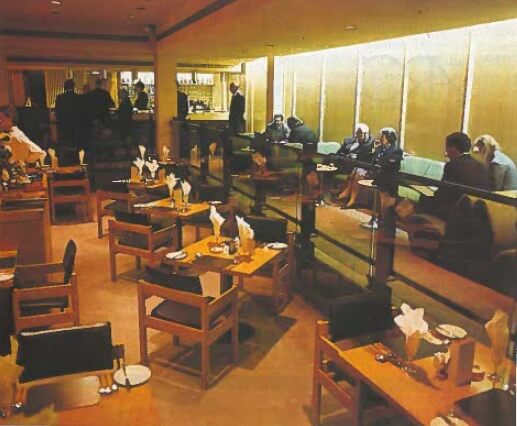 a picture of an empty restaurant with wooden tables and chairs