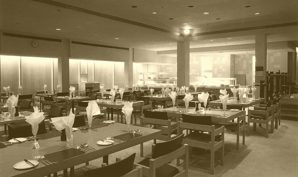 a picture of an empty restaurant with wooden tables and chairs
