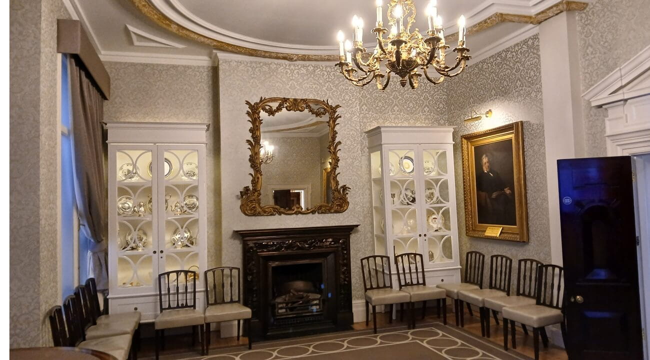 a picture of  a boardroom with paintings on the wall