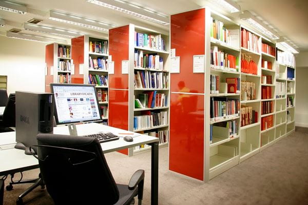 library book shelves and a computer on a desk