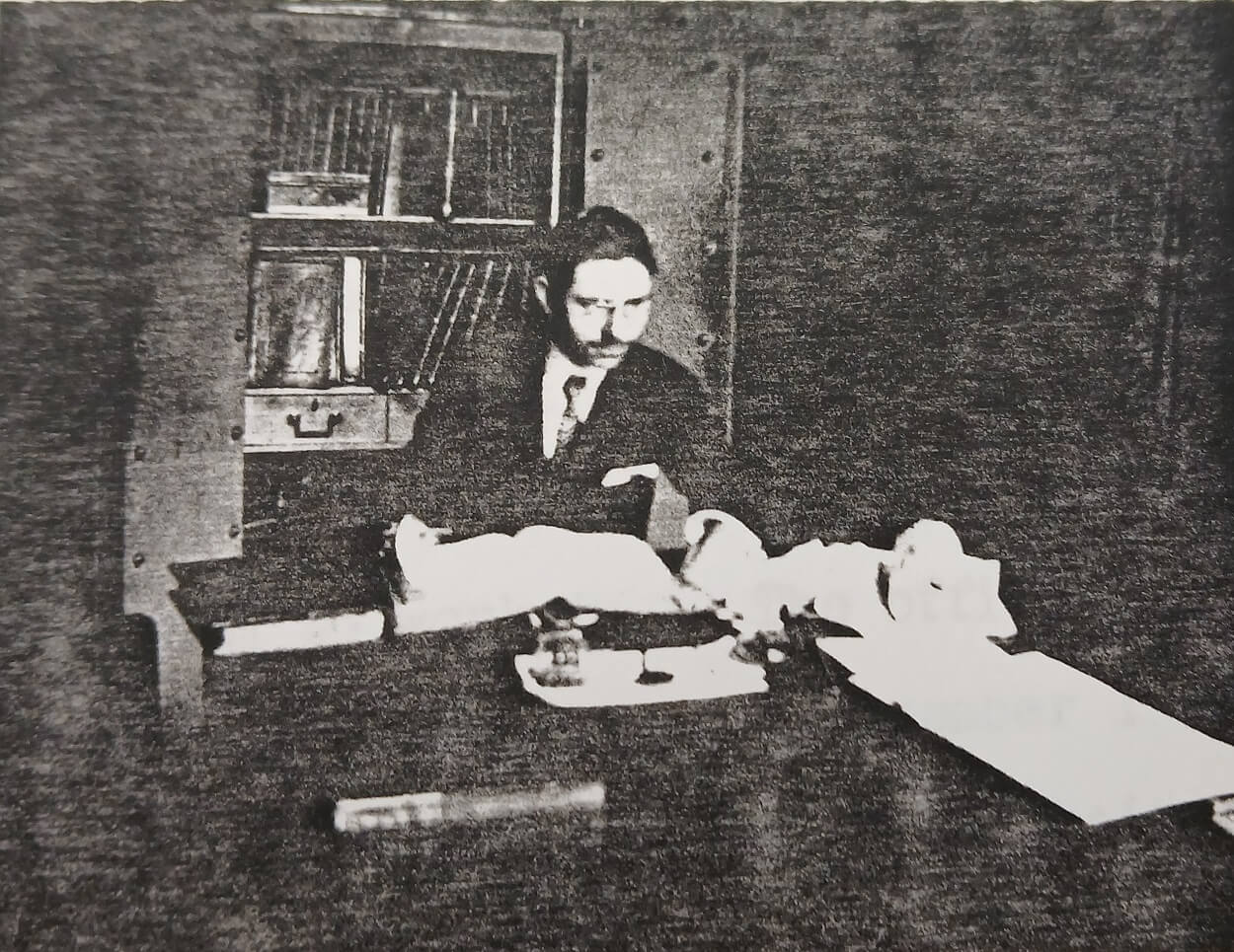 Vintage photograph of a man sitting a desk