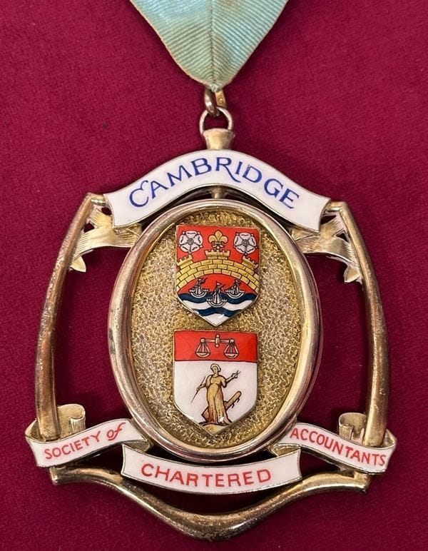 A medal bearing the name of the Cambridge Society of Chartered Accountants.