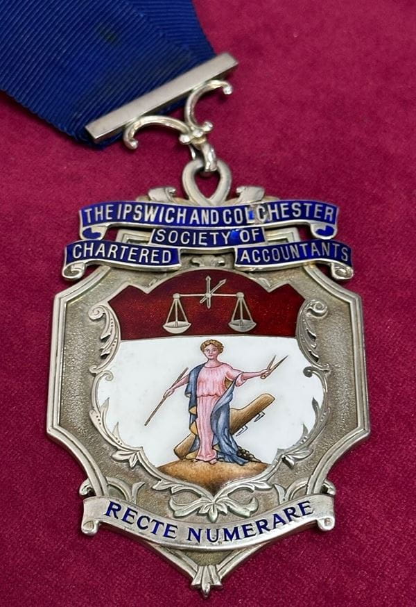 A medal bearing the name of the Ipswich and Colchester Society of Chartered Accountants.