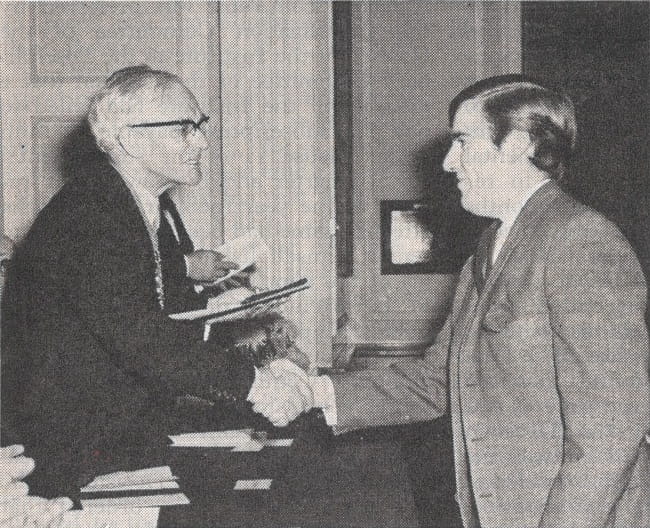 Black and white photograph of two men shaking hands at a prize giving