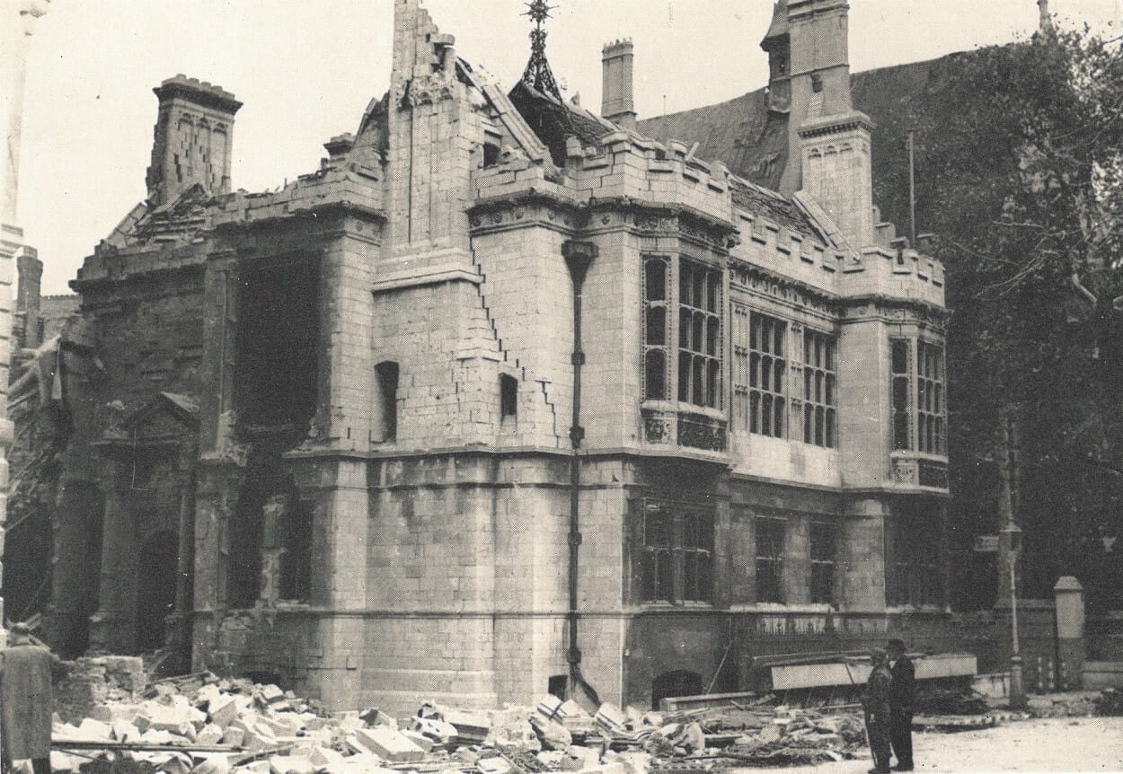 A black and white photograph of a badly damaged building