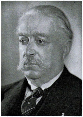 Vintage black and white headshot of man with a droopy moustache