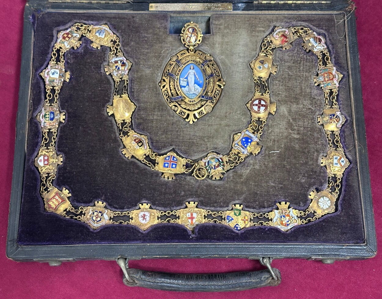 a picture of an ornamental chains of office, gold and coloured enamels in a presentation box