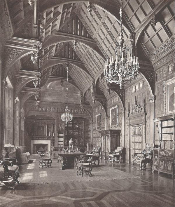 A black and white photograph of an ornate room with chandeliers, wood panelling and wood inlay floor