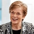Picture of a woman sitting at a desk with pen and paper