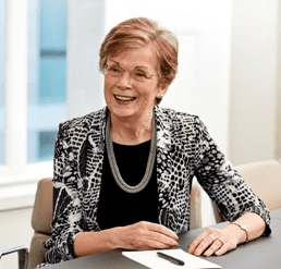 Picture of a woman sitting at a desk with pen and paper