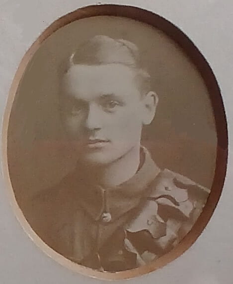 Vintage photograph headshot of a young man in army uniform