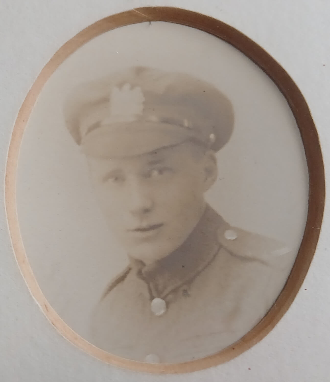 Vintage photograph headshot of a young man in army uniform