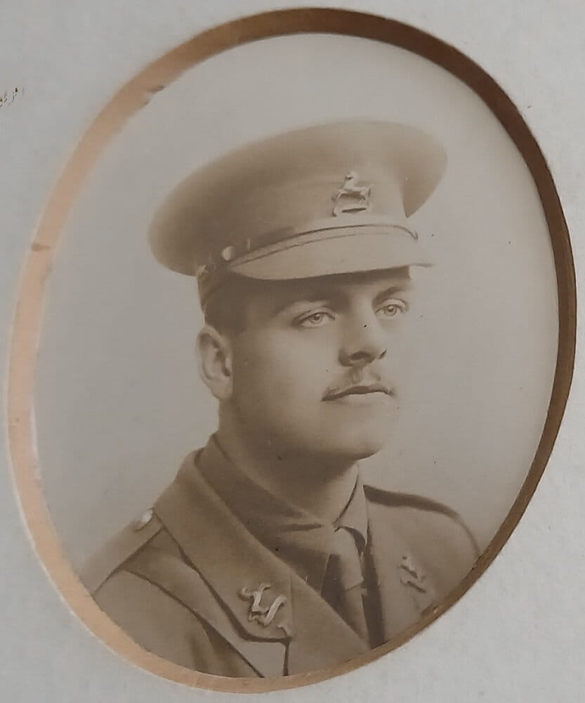 Vintage photograph headshot of a young man in army uniform
