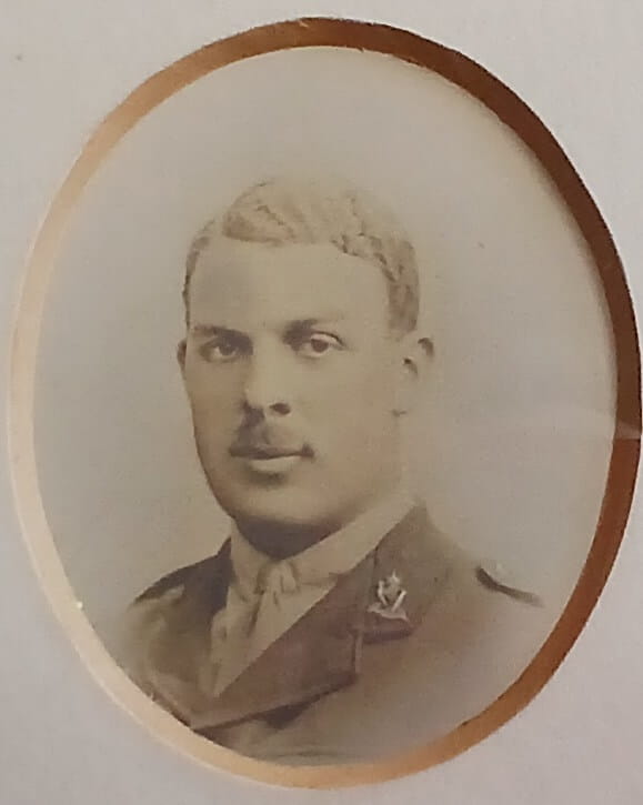 Vintage photograph headshot of a young man in army uniform