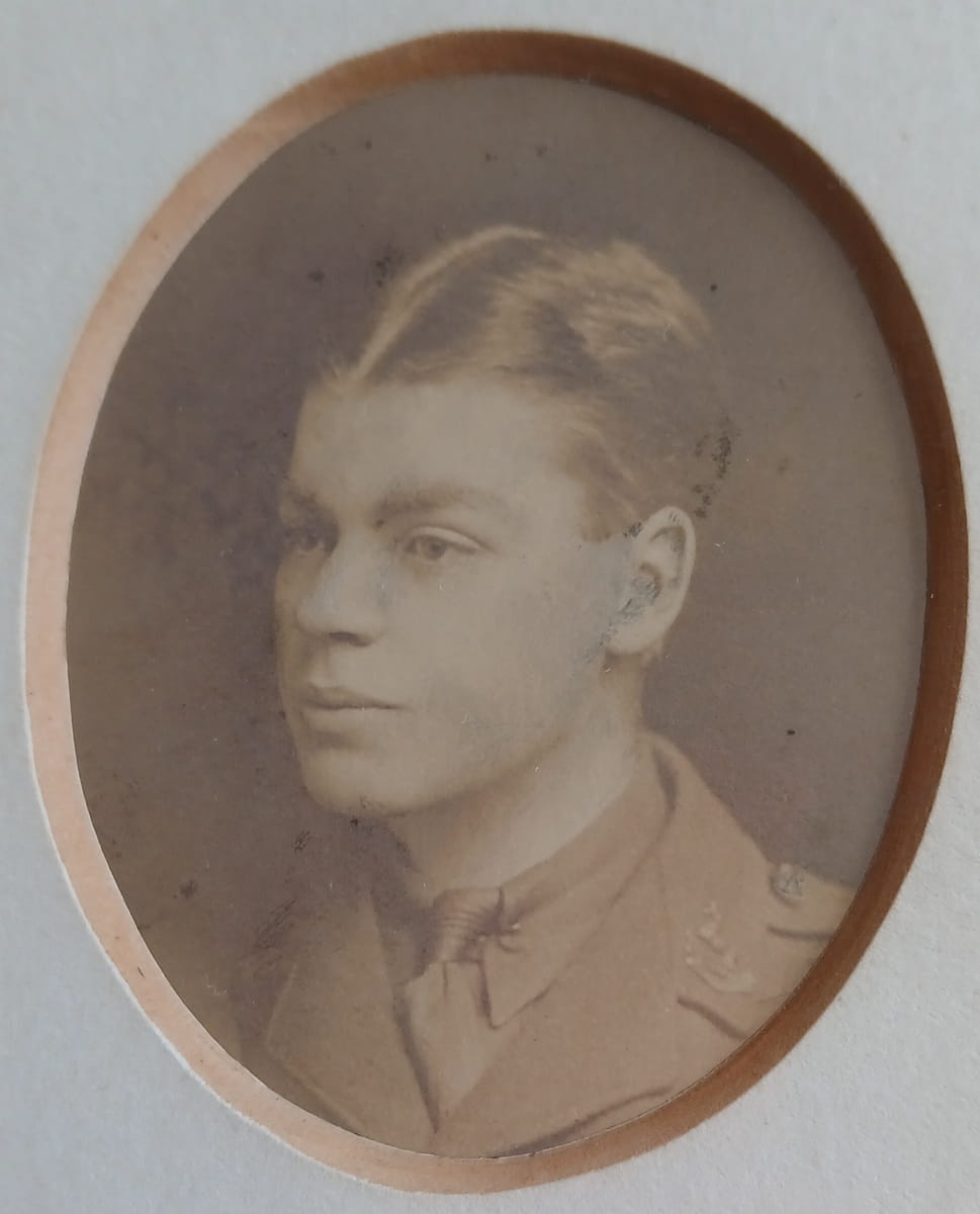 Vintage photograph headshot of a young man in army uniform