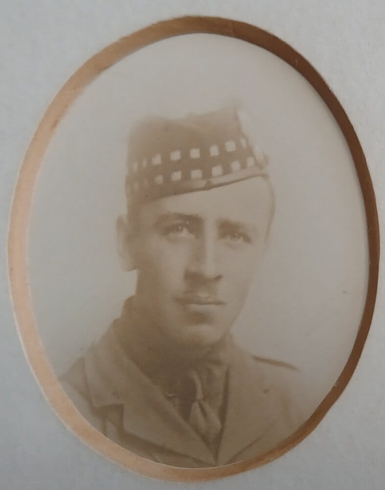 Vintage photograph headshot of a young man in army uniform