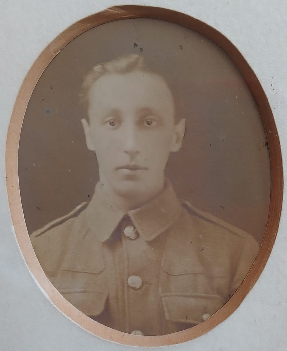 Vintage photograph headshot of a young man in army uniform