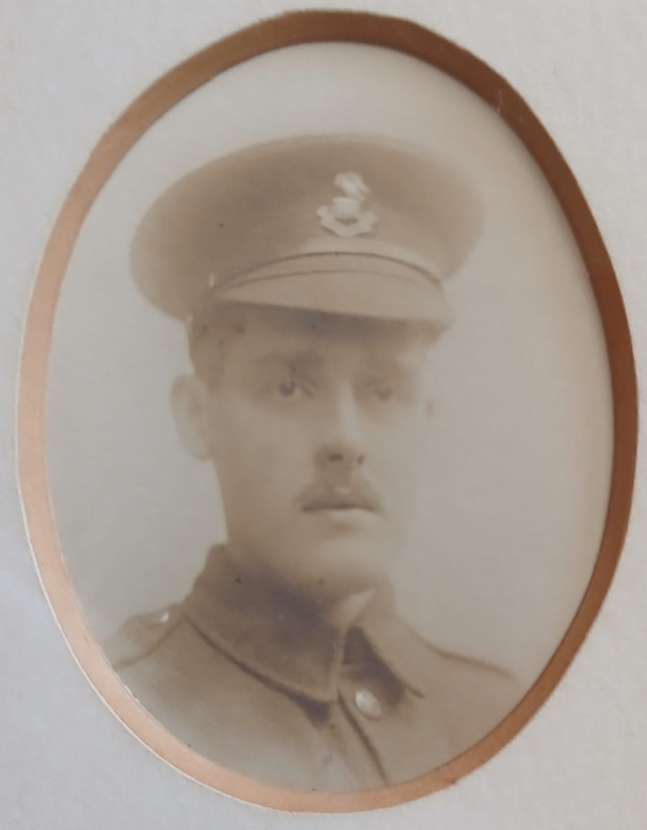 Vintage photograph headshot of a young man in army uniform