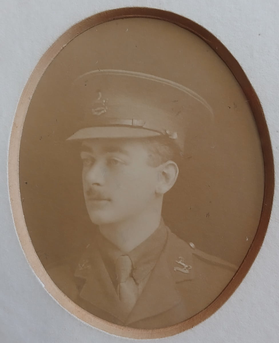 Vintage photograph headshot of a young man in army uniform