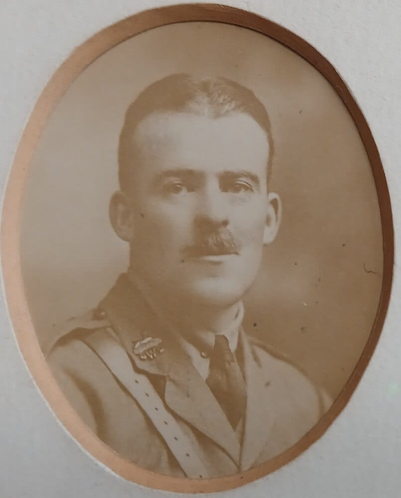 Vintage photograph headshot of a young man in army uniform