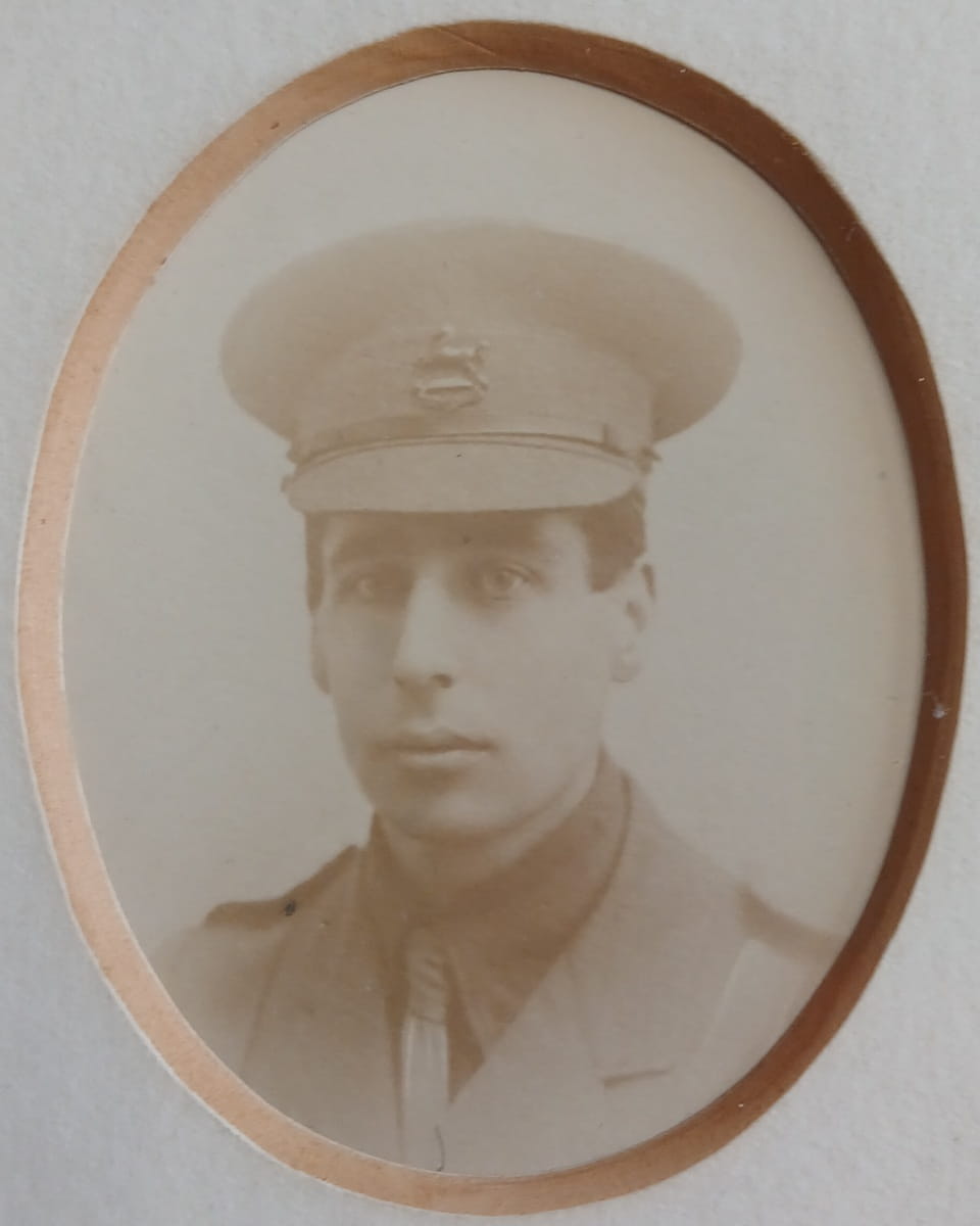 Vintage photograph headshot of a young man in army uniform