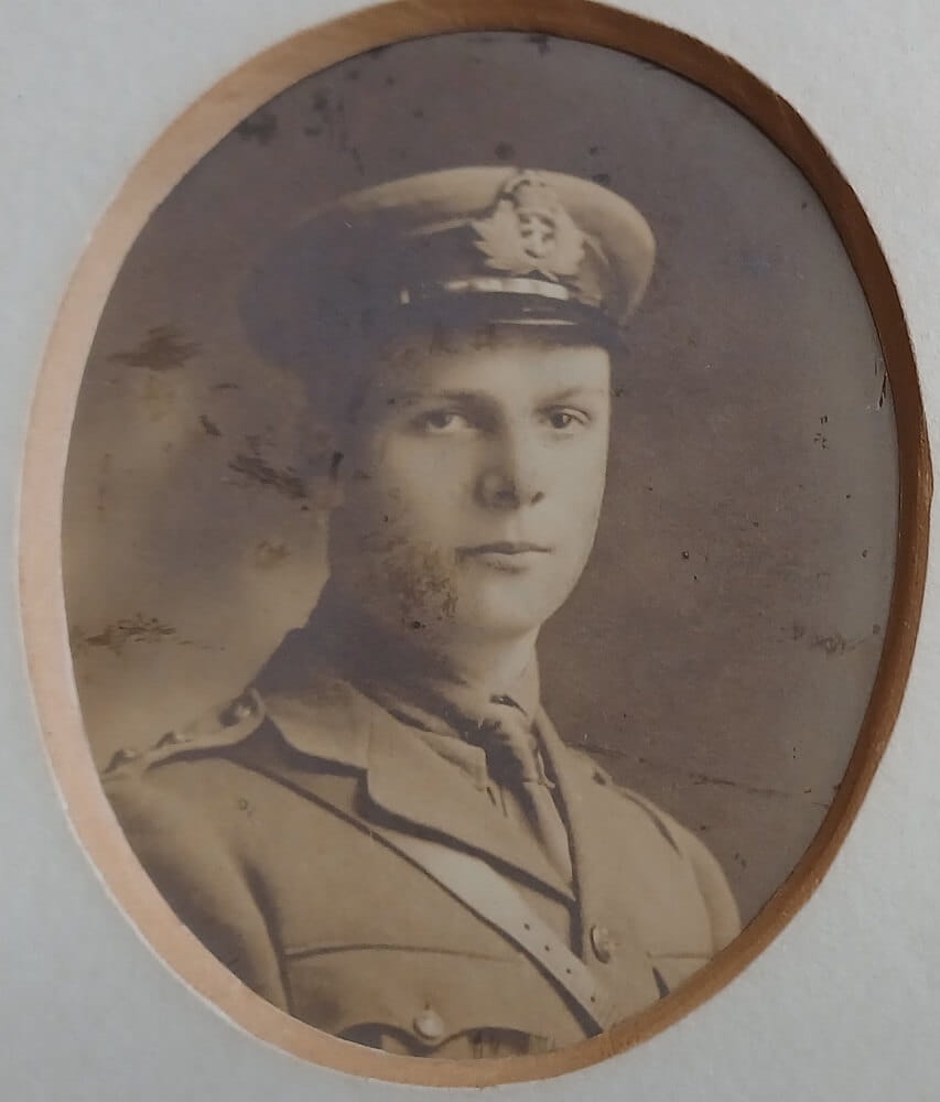 Vintage photograph headshot of a young man in navy uniform