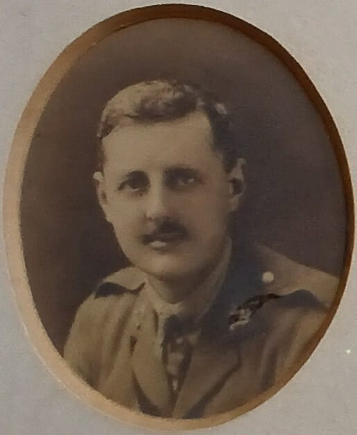 Vintage photograph headshot of a young man in army uniform