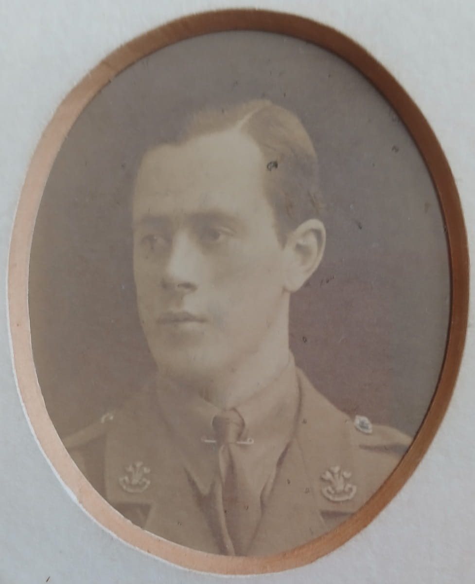 Vintage photograph headshot of a young man in army uniform