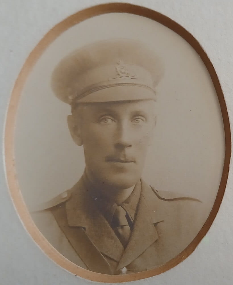 Vintage photograph headshot of a young man in army uniform