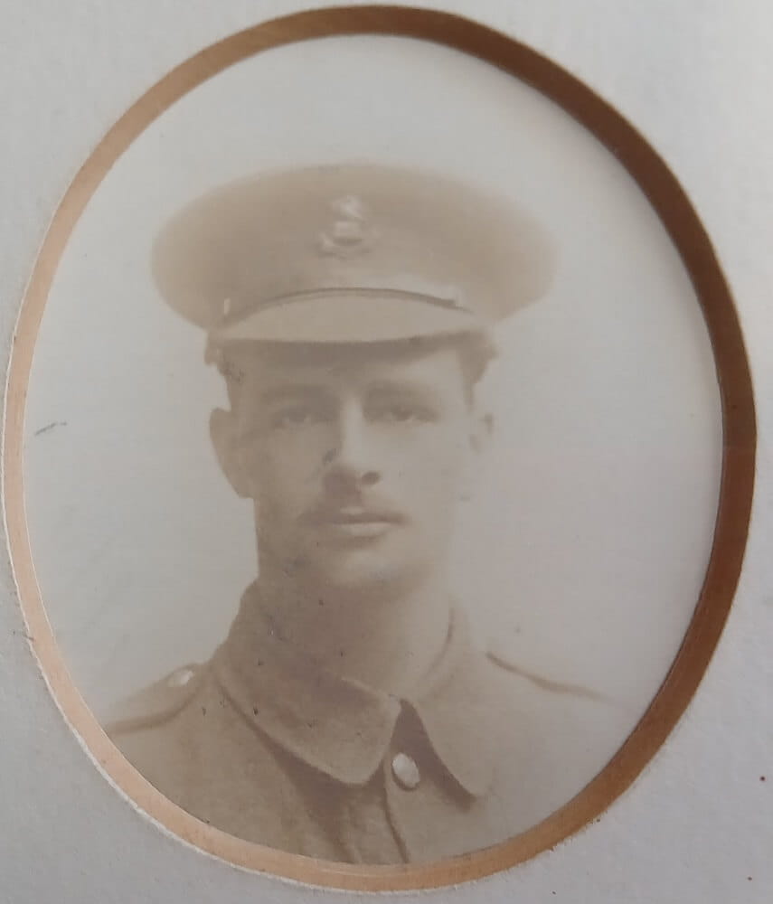 Vintage photograph headshot of a young man in army uniform