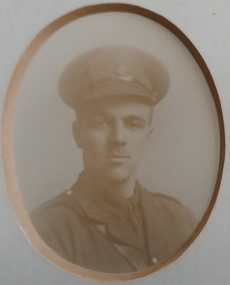 Vintage photograph headshot of a young man in army uniform