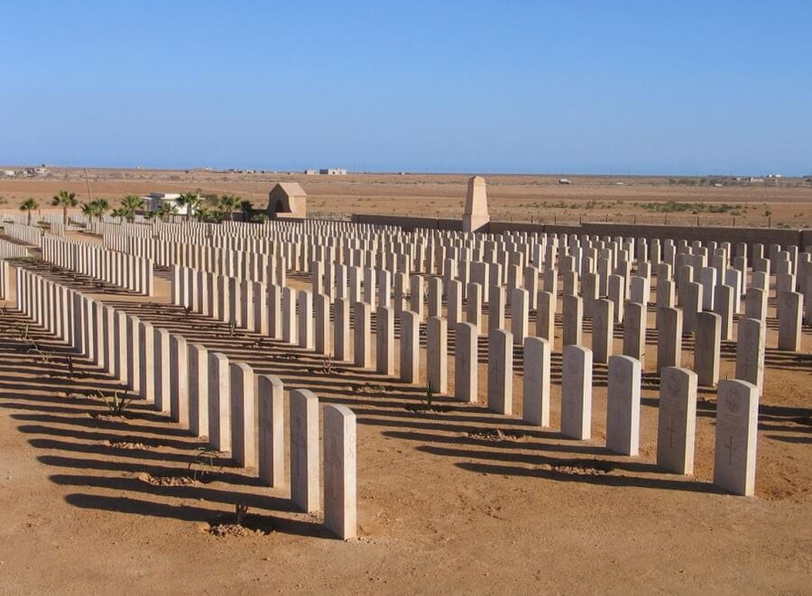 A picture of a graveyard in a desert landscape