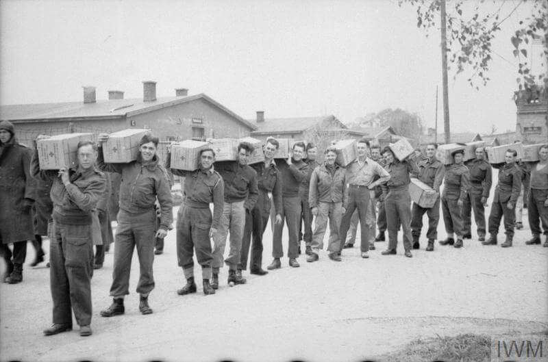 black and white vintage photo of world war 2 British prisoners of war with food parcels