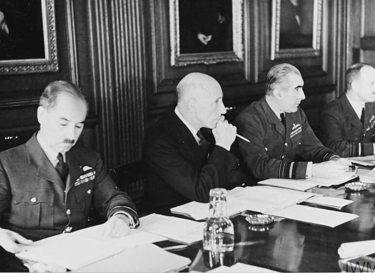 A group of men around a boardroom table, most in RAF uniform
