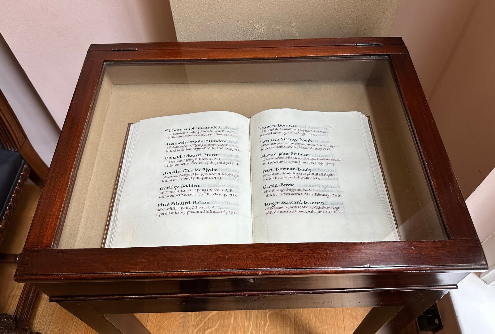 A photograph of a memorial book in a glass case