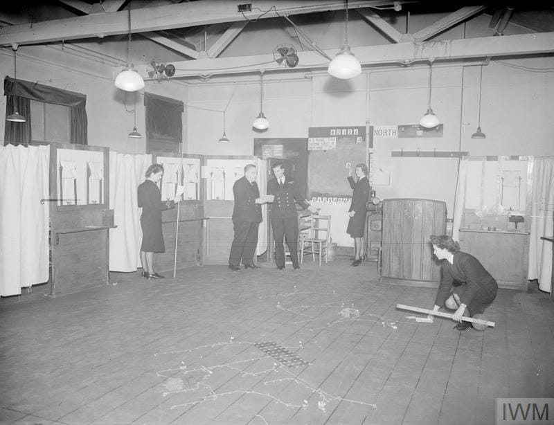 The Tactical Table ready for the next move. Jean Laidlaw is the Wren Officer on the left. The Western Approaches Tactical Unit, Derby House. 18 March 1945 Image: © IWM (A 27818)