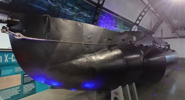 Photograph of a small submarine in a museum setting