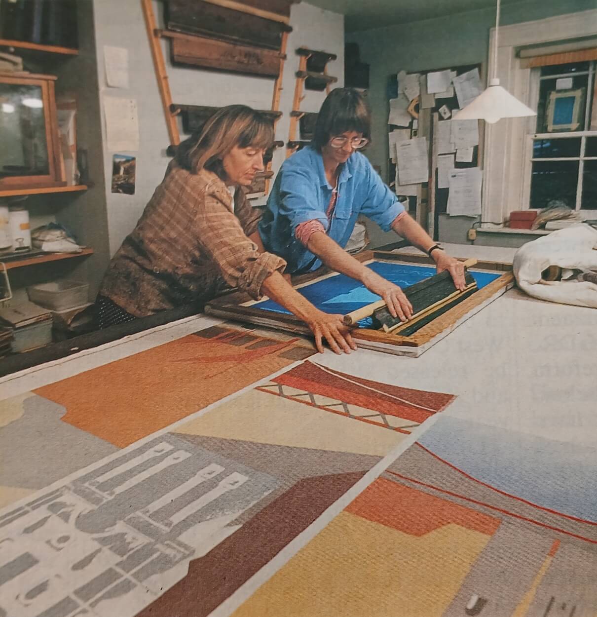 image of two women working in an art studio, screen printing
