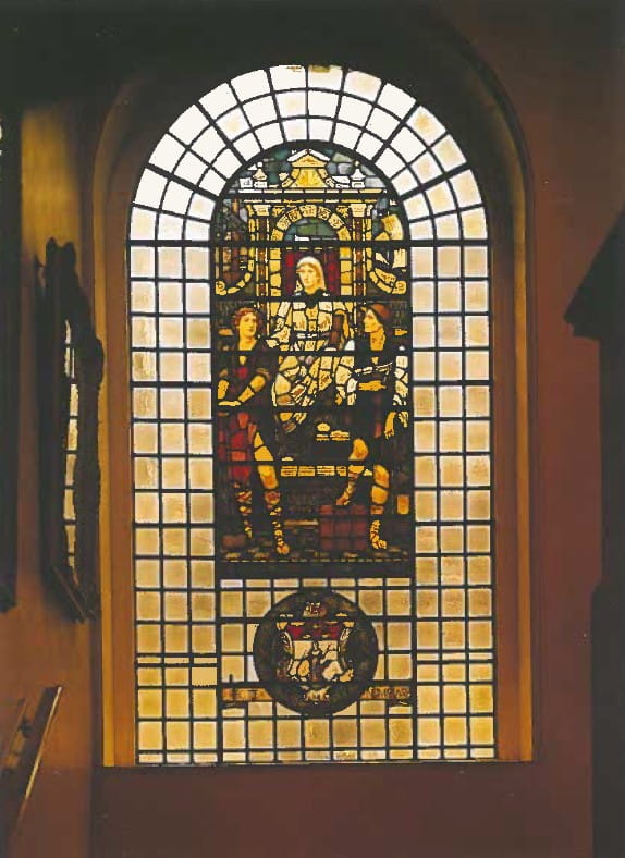 Photo showing one of Holiday's windows — Manufacture and Commerce directed by Experience — after the post-war restoration.