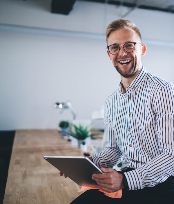 Image of smiling man holding tablet