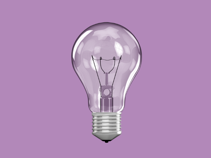 Light bulb on purple background