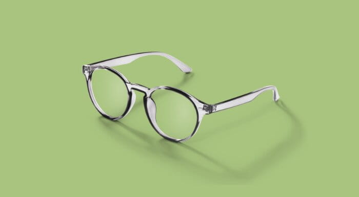 Silver glasses on a green background