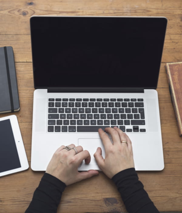 Birdseye view of a pair of hands typing on a laptop