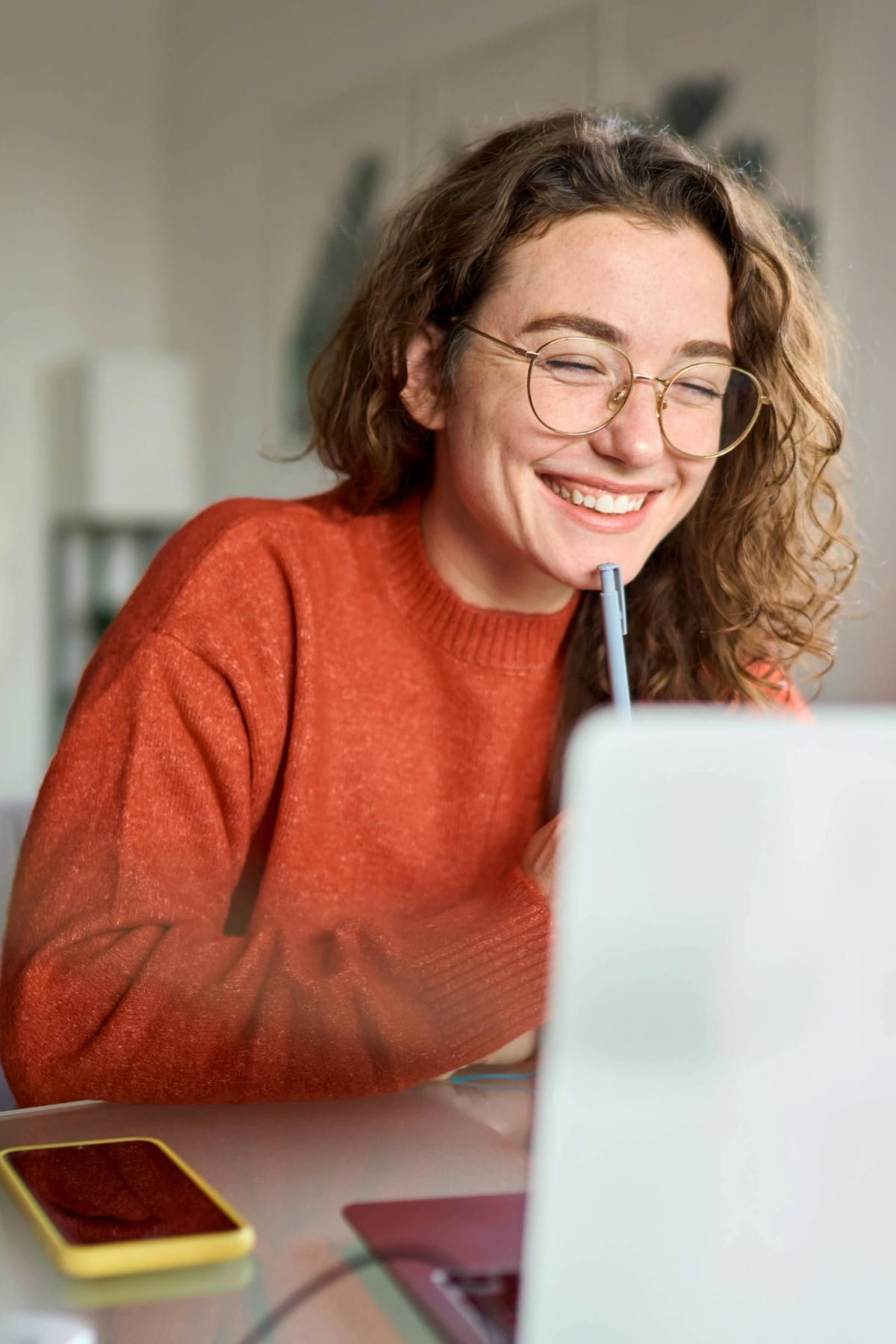 Girl smiling at laptop